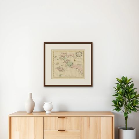 Antique Map extending from the Spice Islands to the west of Papua New Guinea, shown framed on a wall, true to size